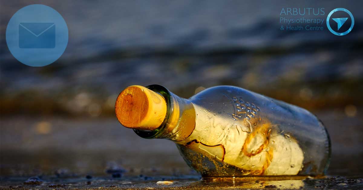 A message in a bottle, resting in the intertidal zone of a Pacific Northwest beach.