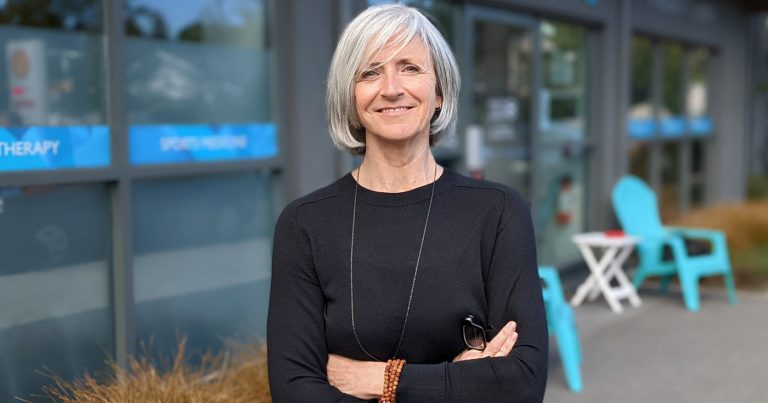 Kathi Ells stands outside of the physiotherapy clinic on Oak Bay Ave.