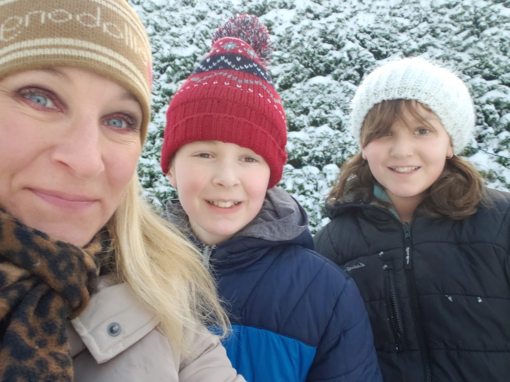 Natasha Watson takes a selfie with her fraternal twins in the winter, as they all wear toques and jackets.