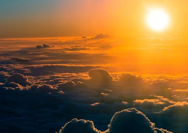The sun shines over a sea of clouds.