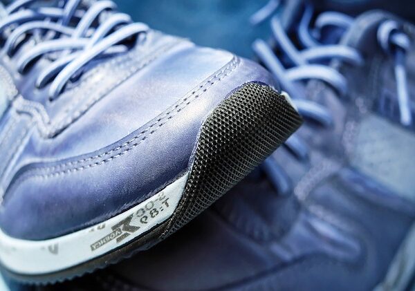 A close up of a pair of blue athletic sneakers.