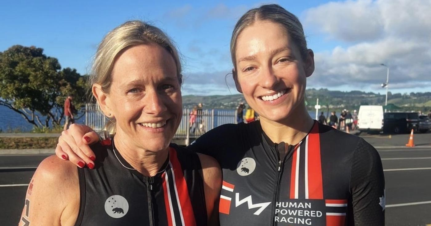 Sandy Wilson and Madison P Lloyd stand smiling in New Zealand after the 70.3 Triathlon.