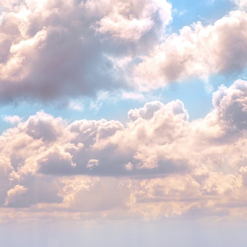 Pink clouds against a light blue sky.
