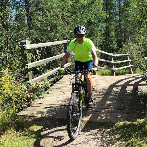 Margaret Kavanagh rides a moutain bike on a forest trail.