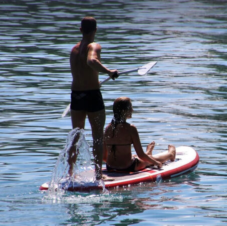 A paddler with a passenger on a hot day in Victoria.